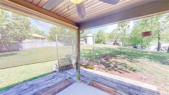 wooden terrace featuring a lawn, a ceiling fan, and fence