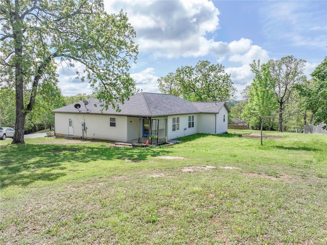 back of house with a yard
