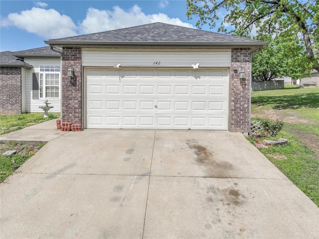 garage featuring concrete driveway