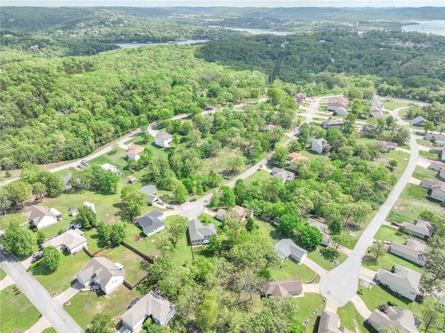 birds eye view of property featuring a view of trees and a residential view