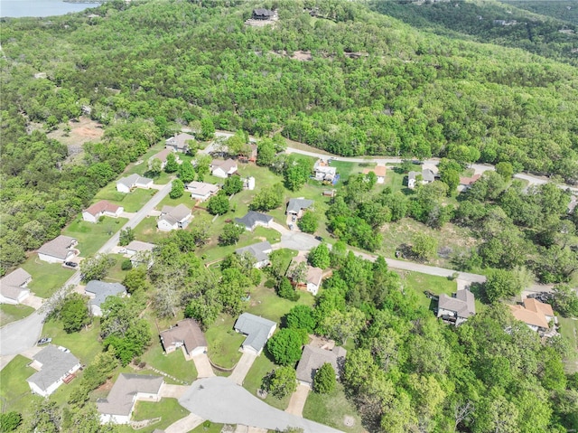 drone / aerial view featuring a residential view and a forest view