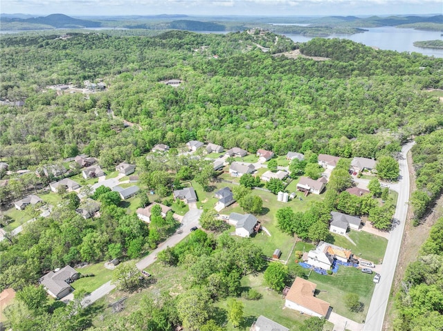 drone / aerial view with a water view, a forest view, and a residential view