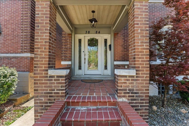 entrance to property featuring brick siding