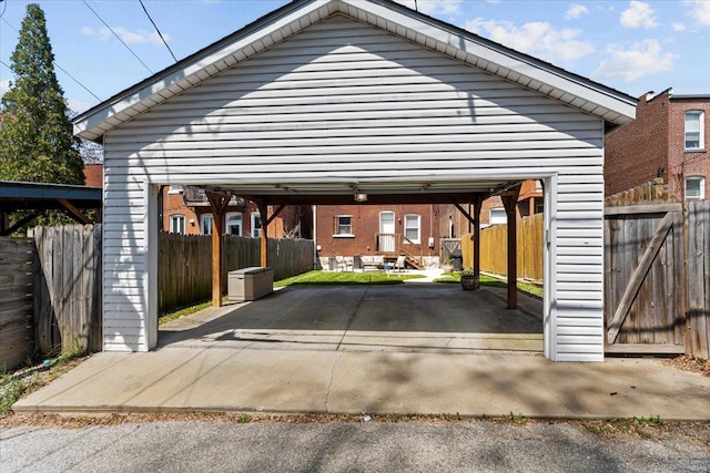 view of vehicle parking with fence