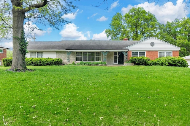 ranch-style home featuring a front yard and brick siding