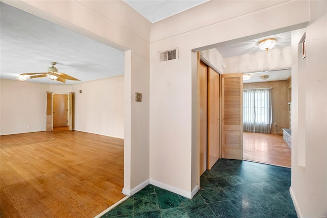 corridor featuring visible vents and baseboards