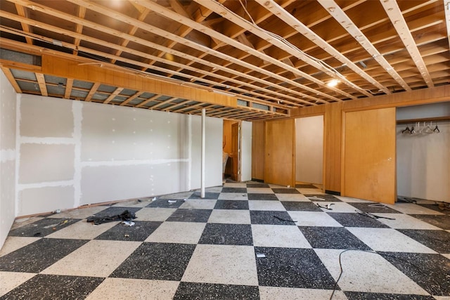 finished below grade area featuring tile patterned floors