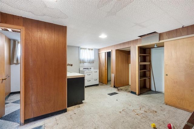 unfurnished bedroom with two closets and wood walls