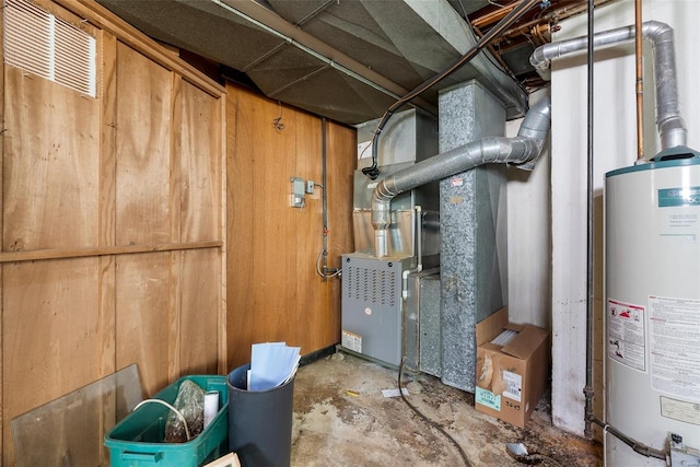 utility room with gas water heater and visible vents