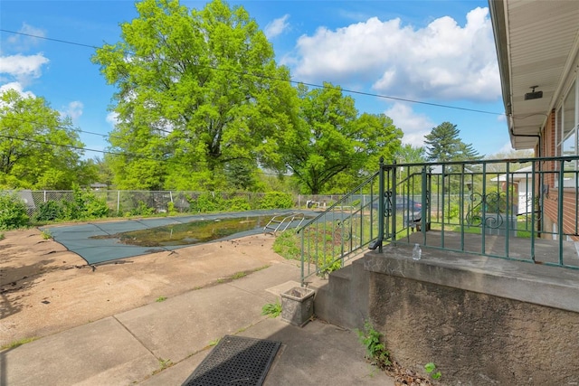 view of patio with a fenced in pool and fence