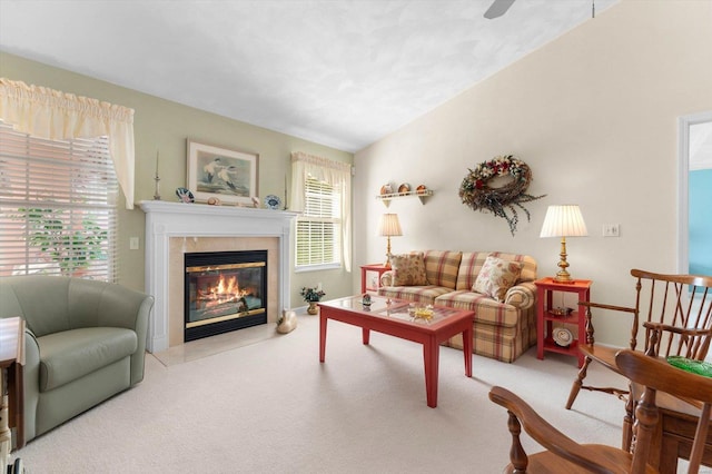 living area featuring a fireplace, carpet, and ceiling fan