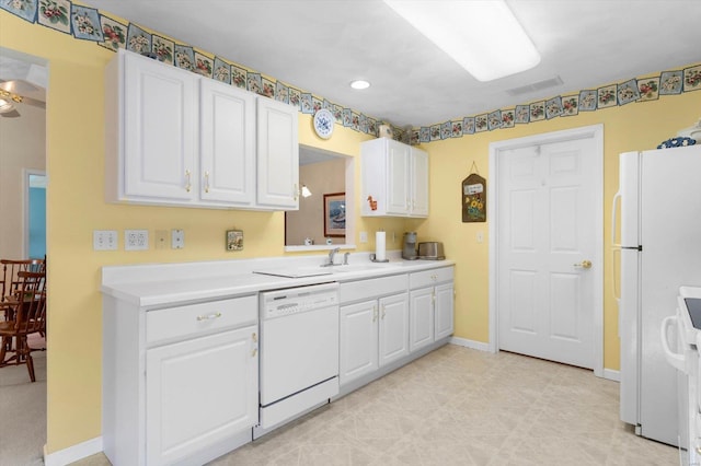kitchen featuring light countertops, a sink, white appliances, baseboards, and white cabinetry