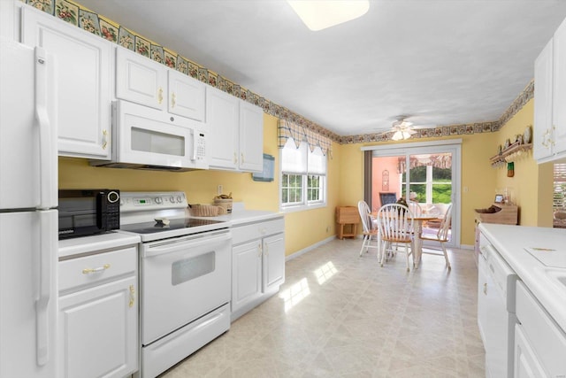 kitchen with white cabinets, light countertops, a ceiling fan, white appliances, and baseboards