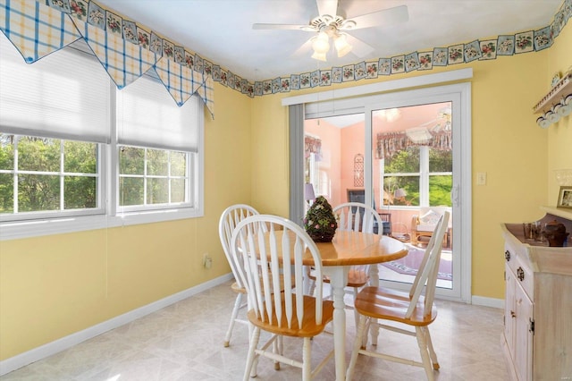 dining area featuring a ceiling fan, baseboards, and a wealth of natural light