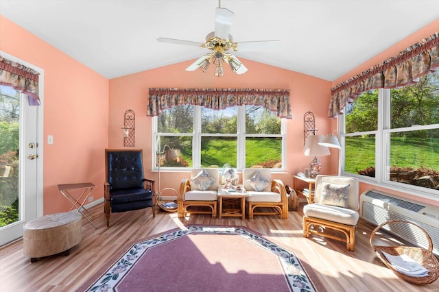 interior space with baseboards, lofted ceiling, ceiling fan, and wood finished floors