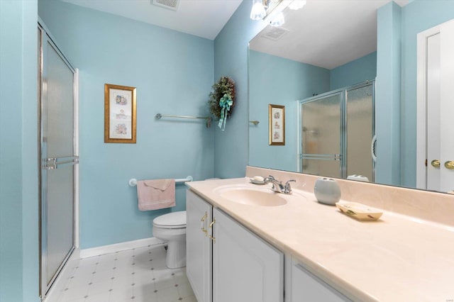bathroom featuring tile patterned floors, toilet, baseboards, a shower stall, and vanity