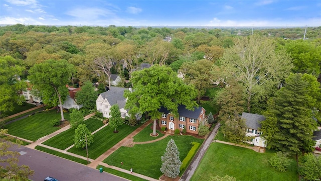 birds eye view of property with a view of trees