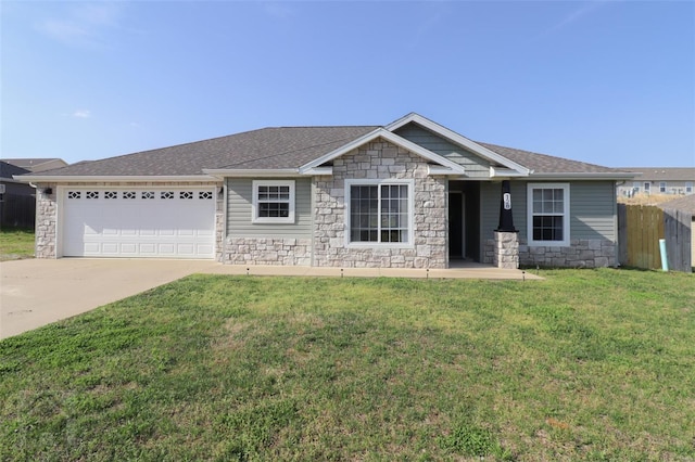 view of front of property featuring driveway, stone siding, an attached garage, fence, and a front yard
