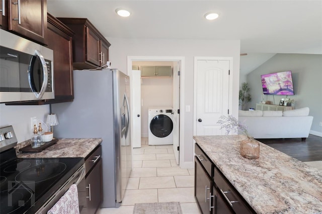 kitchen featuring washer / clothes dryer, dark brown cabinets, appliances with stainless steel finishes, and light stone countertops
