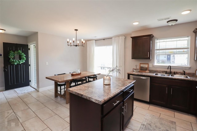 kitchen featuring visible vents, stainless steel dishwasher, light tile patterned floors, a sink, and a chandelier