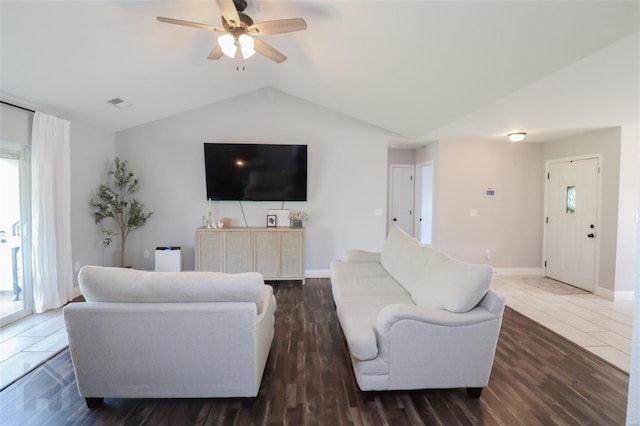 living room with lofted ceiling, baseboards, a wealth of natural light, and ceiling fan