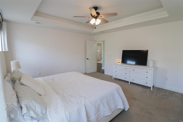 bedroom with a ceiling fan, a tray ceiling, baseboards, carpet flooring, and visible vents