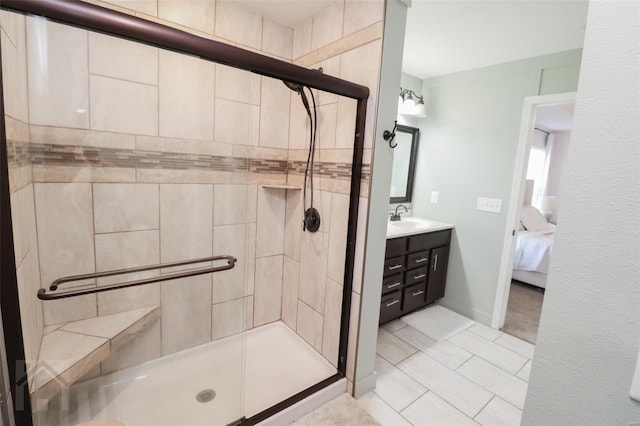 ensuite bathroom with vanity, tile patterned flooring, connected bathroom, and a stall shower