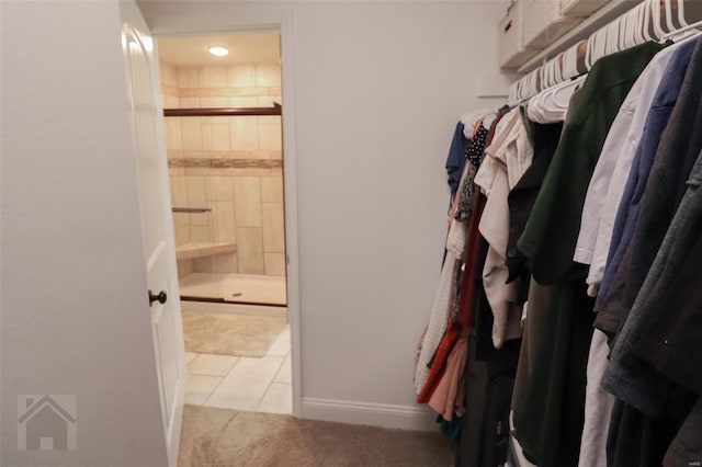 spacious closet with carpet flooring and tile patterned flooring