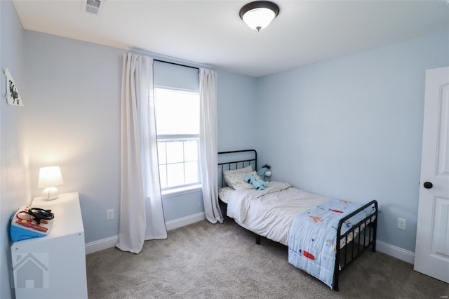 bedroom with carpet floors, visible vents, and baseboards