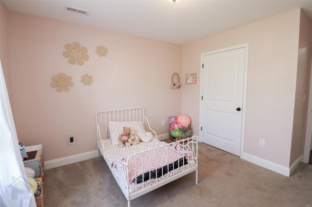 carpeted bedroom featuring baseboards and visible vents