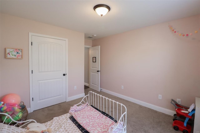 bedroom featuring baseboards and carpet