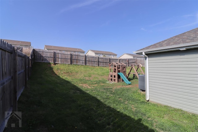view of yard featuring a fenced backyard and a playground