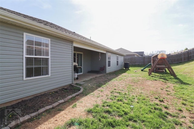 view of yard featuring a fenced backyard, a patio area, and a playground