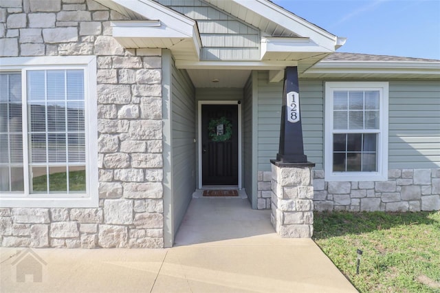 property entrance with stone siding