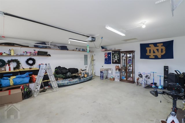 garage with a garage door opener and electric panel
