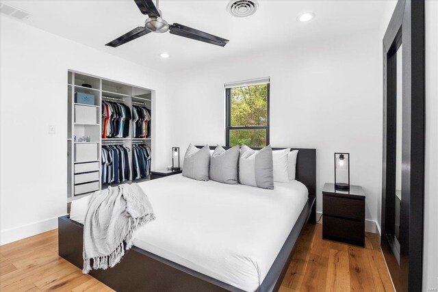 bedroom with visible vents, recessed lighting, wood finished floors, and a closet