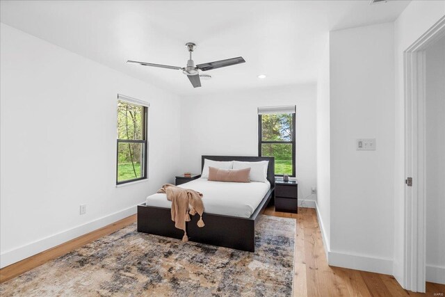 bedroom with light wood-type flooring, recessed lighting, baseboards, and ceiling fan