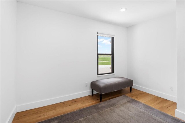 living area featuring baseboards, recessed lighting, and wood finished floors