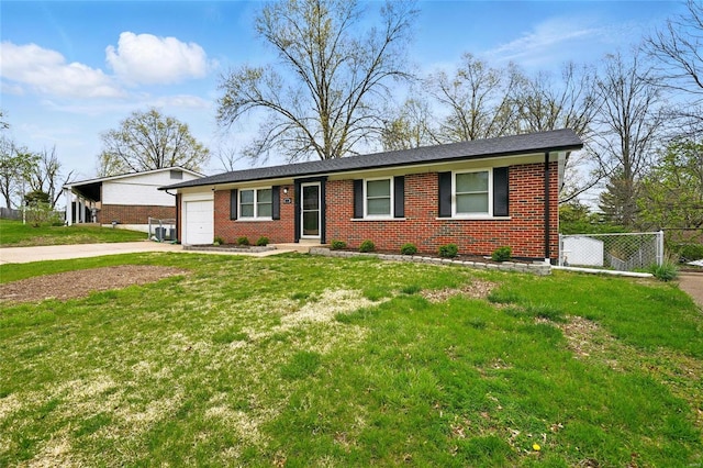 ranch-style house with a garage, a front yard, brick siding, and concrete driveway