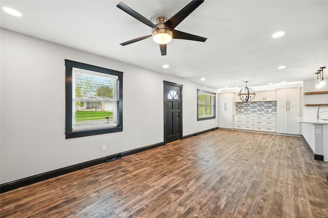 unfurnished living room featuring visible vents, recessed lighting, wood finished floors, and a healthy amount of sunlight