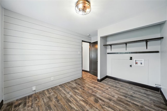 interior space featuring baseboards and dark wood finished floors