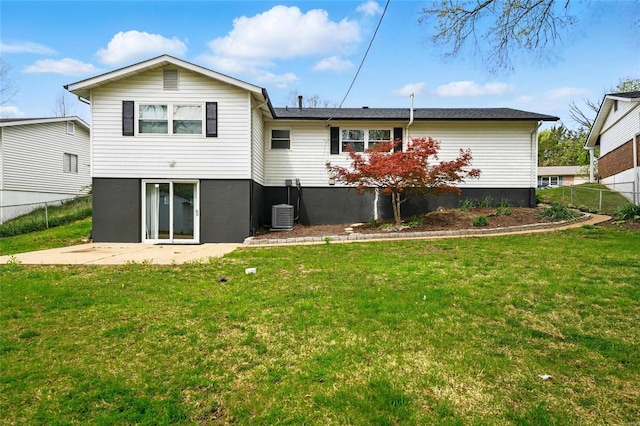 back of house featuring central air condition unit, a patio, a yard, and fence