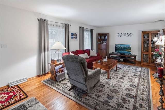 living room featuring hardwood / wood-style floors and visible vents