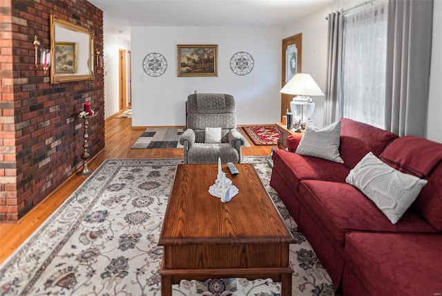 living area with baseboards and wood finished floors
