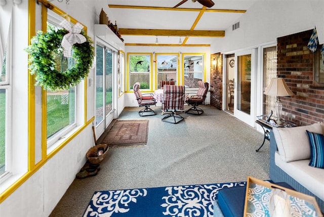 sunroom with lofted ceiling with beams, carpet flooring, brick wall, and visible vents