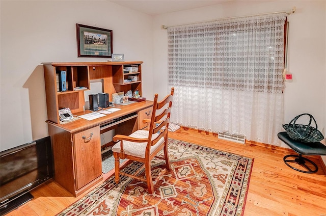office featuring wood finished floors and visible vents