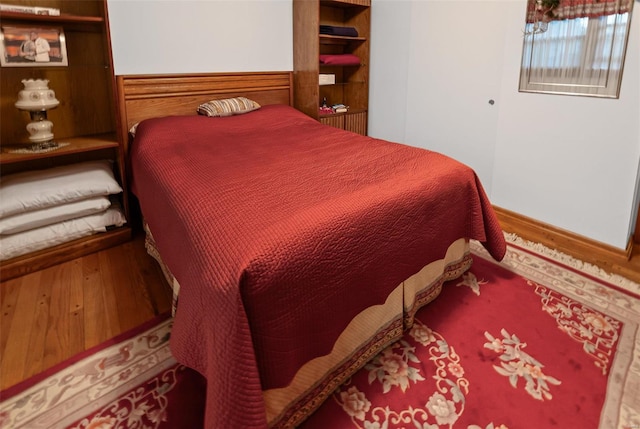 bedroom with wood finished floors