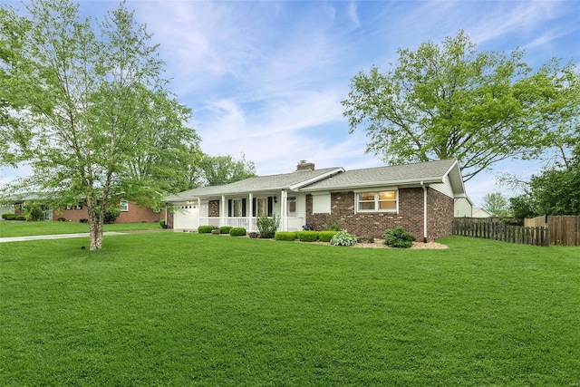 ranch-style house with brick siding, fence, covered porch, and a front yard