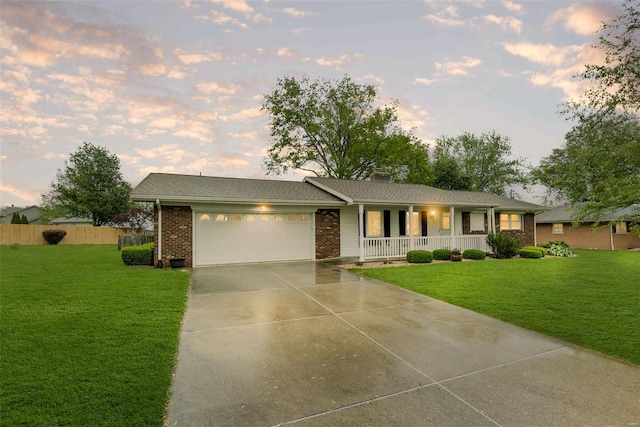 single story home featuring a garage, a front yard, covered porch, and driveway
