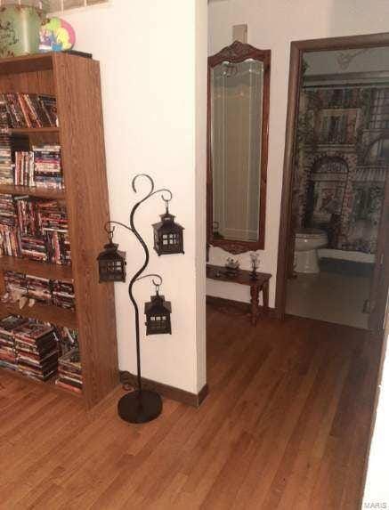 hallway with baseboards and wood finished floors